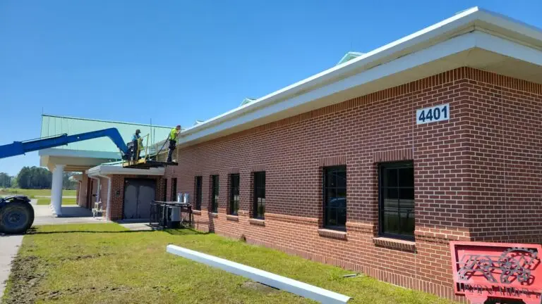 New gutters being installed by Olde South Contractors as part of commercial roofing in Savannah