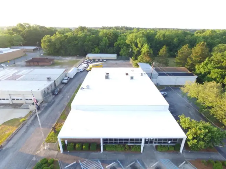 Look at this drastic change in a flat roof in Swainsboro. We took it from worn out gravel to a beautiful new TPO roof!